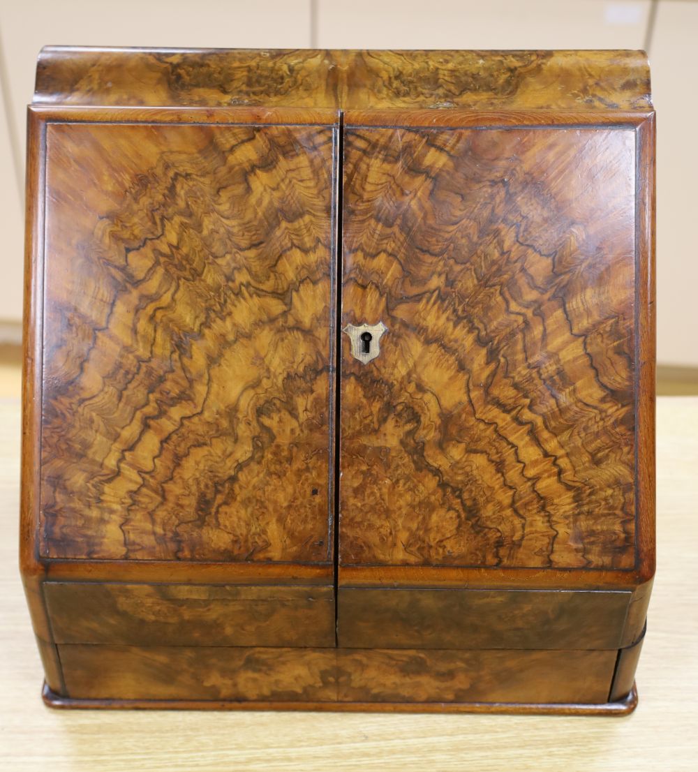 A Victorian figured walnut table stationery cabinet